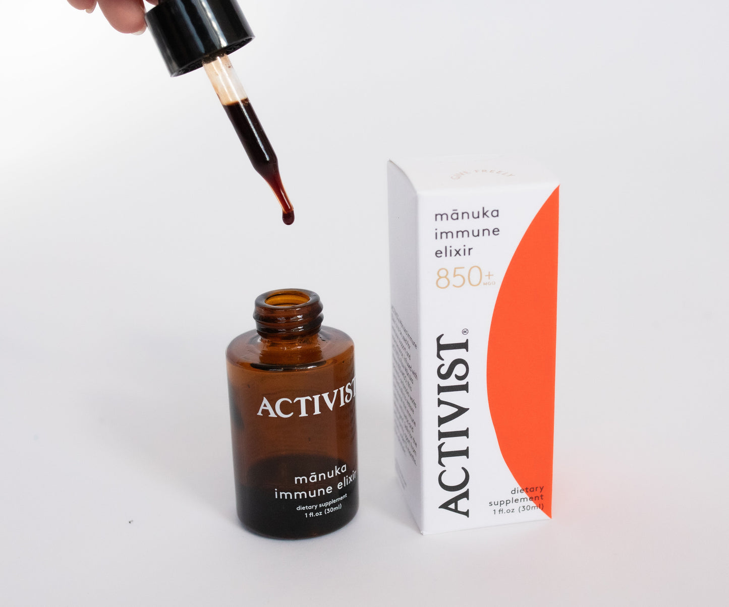 Brown bottle with dropper and Activist packaging on a white background